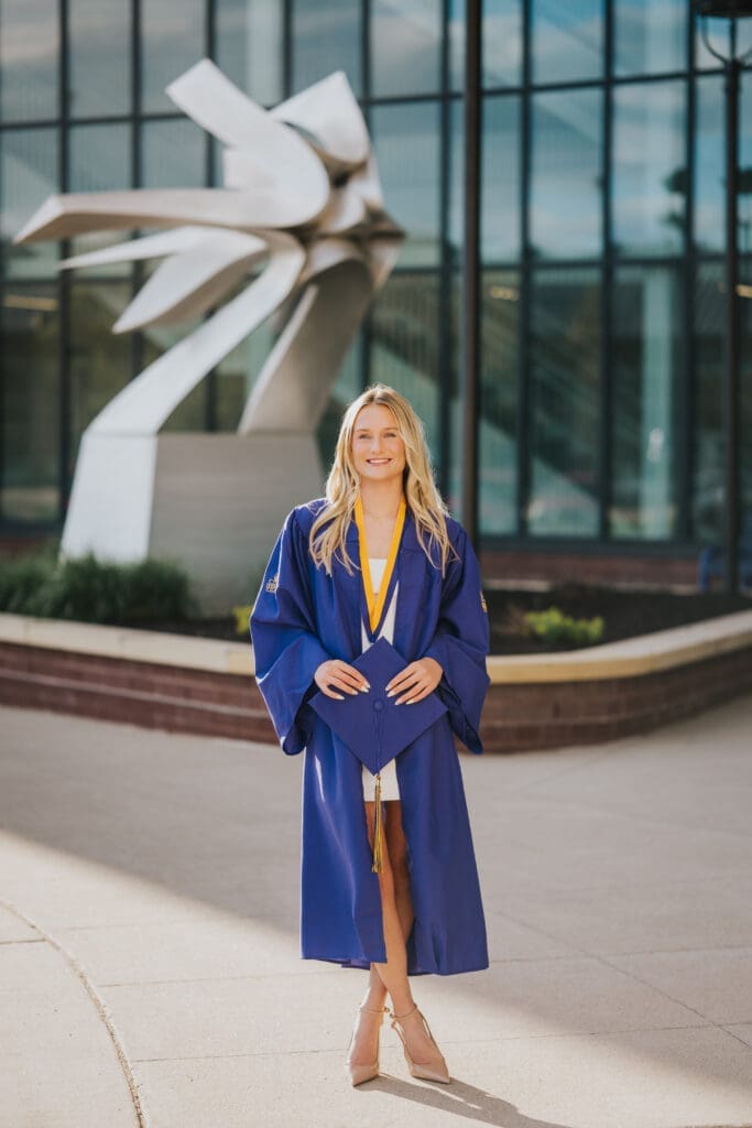 College graduate in purple cap and gown at Minnesota State University Mankato