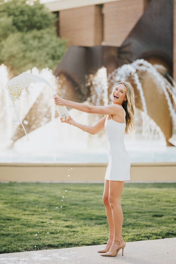 College graduation photos by fountain at Minnesota State University Mankato during golden hour